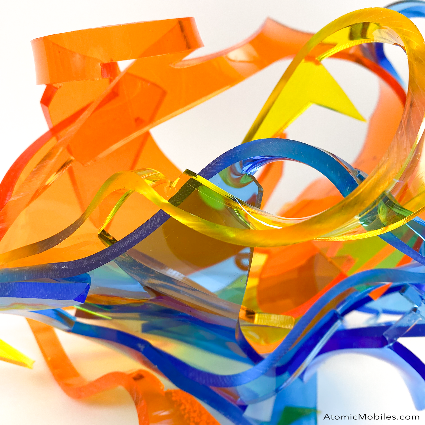 Another view of Dream Abstract Art Sculpture from the Sculptura Collection of incredibly unique art sculptures hand made with earth-friendly upcycled acrylic plexiglass by Debra Ann of AtomicMobiles.com in Los Angeles, featuring bold colors of clear orange, clear blue, and clear yellow