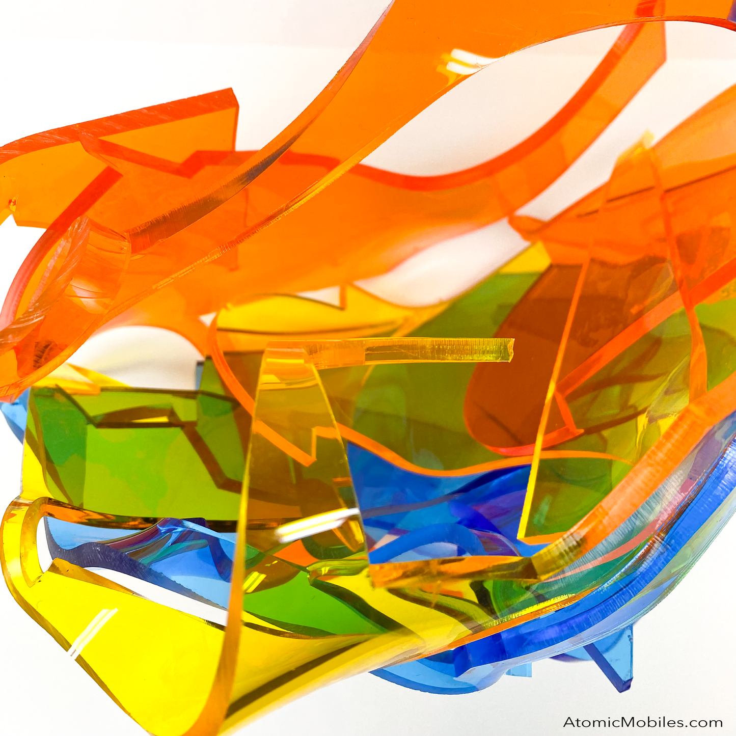 Top view of Dream Abstract Art Sculpture from the Sculptura Collection of incredibly unique art sculptures hand made with earth-friendly upcycled acrylic plexiglass by Debra Ann of AtomicMobiles.com in Los Angeles, featuring bold colors of clear orange, clear blue, and clear yellow