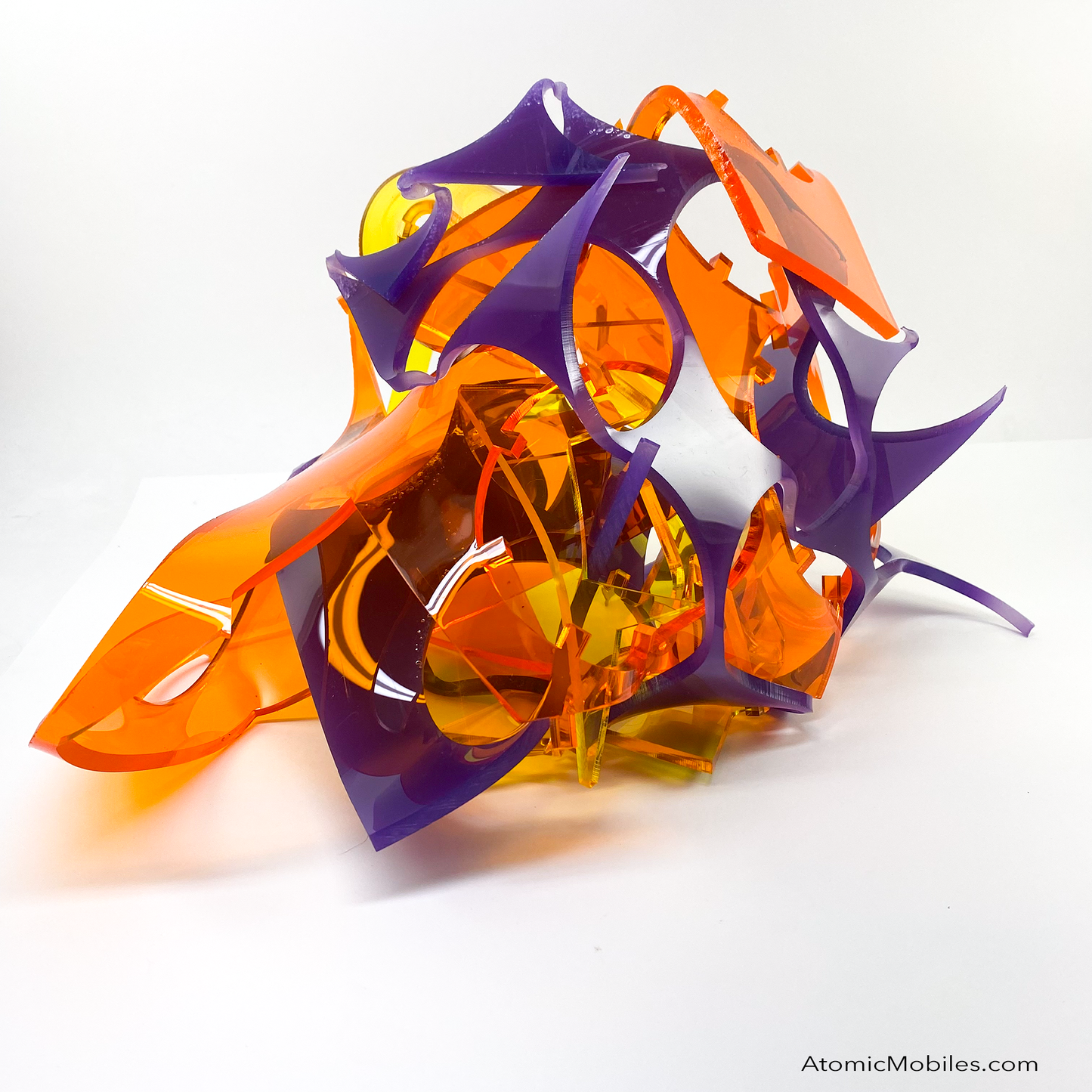 Back view of one of a kind Stellar abstract art sculpture in bold clear orange, clear yellow, and opaque purple - made from recycled/upcycled acrylic plexiglass by Debra Ann in Los Angeles of AtomicMobiles.com