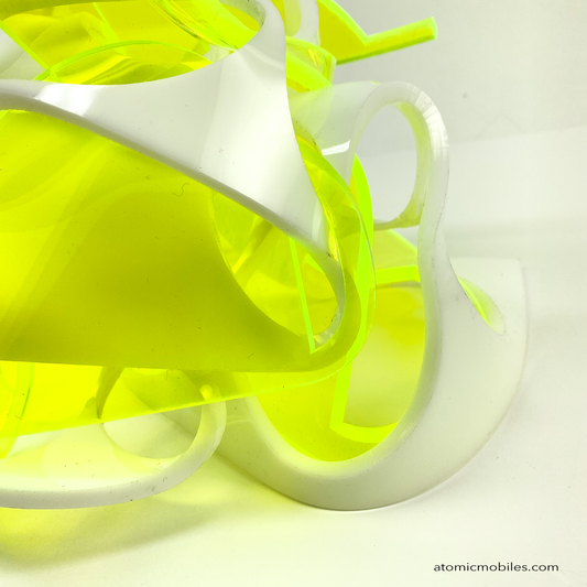 Closeup of Thrill abstract art sculpture in neon fluorescent green and opaque white acrylic plexiglass - upcycled and recycled acrylic one-of-a-kind modern art by Debra Ann of AtomicMobiles.com in Los Angeles