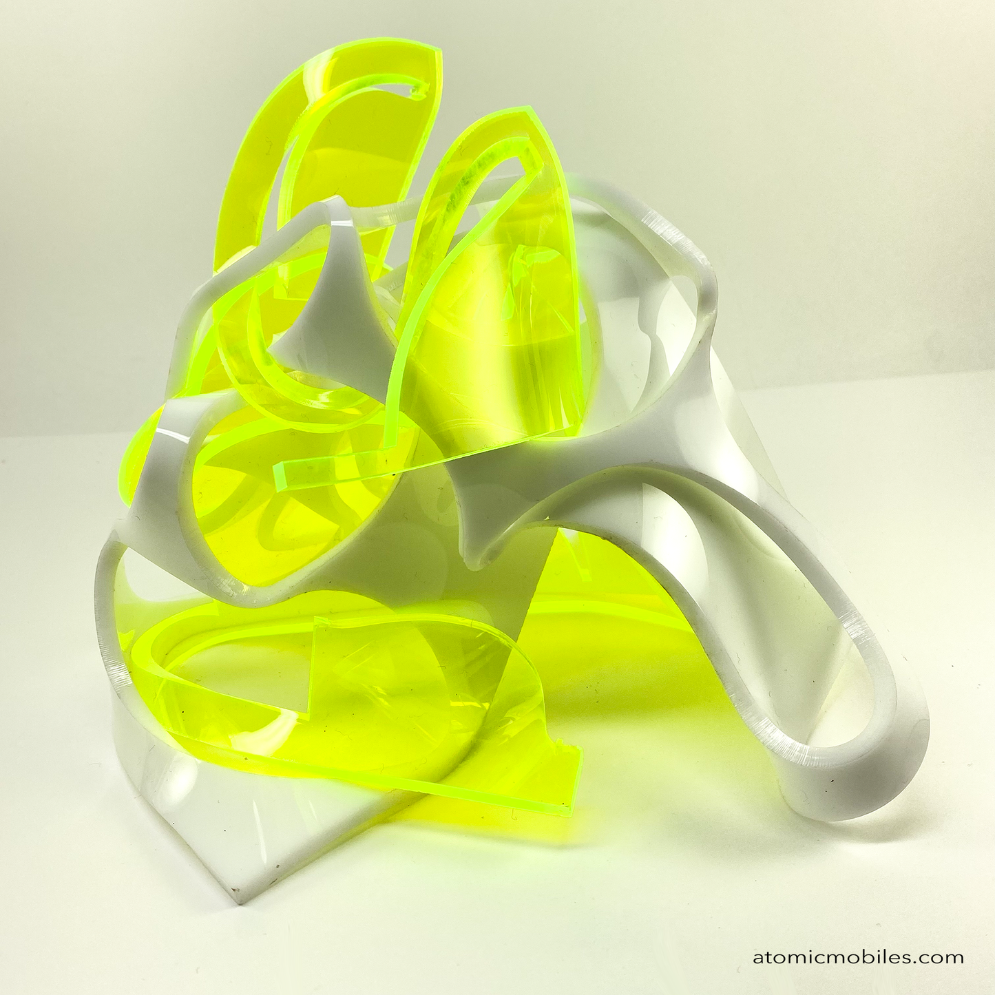 Back view of oThrill abstract art sculpture in neon fluorescent green and opaque white acrylic plexiglass - upcycled and recycled acrylic one-of-a-kind modern art by Debra Ann of AtomicMobiles.com in Los Angeles