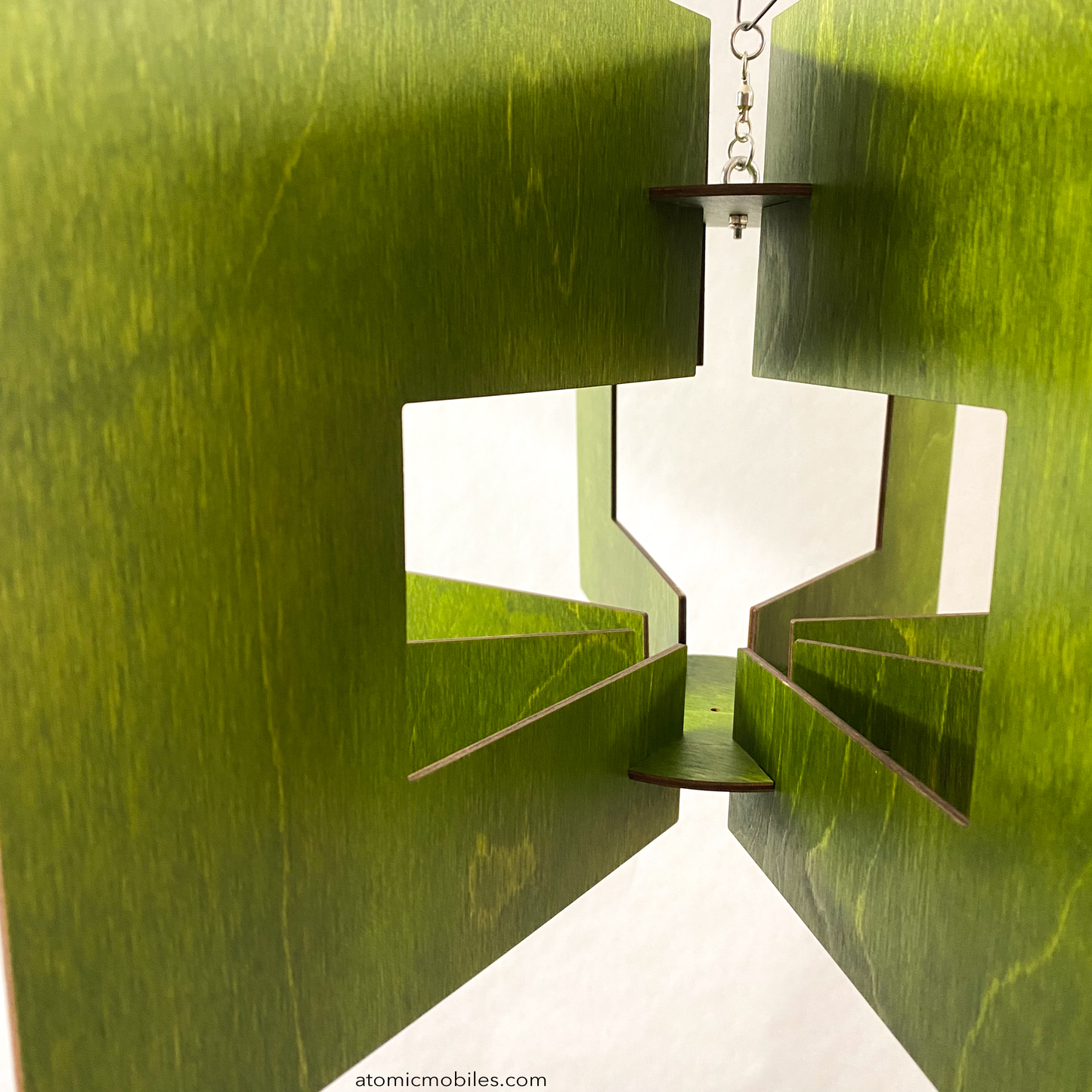 Closeup of SPACE AGE hanging kinetic art mobile sculpture in lovely KIWI Green stained wood by AtomicMobiles.com