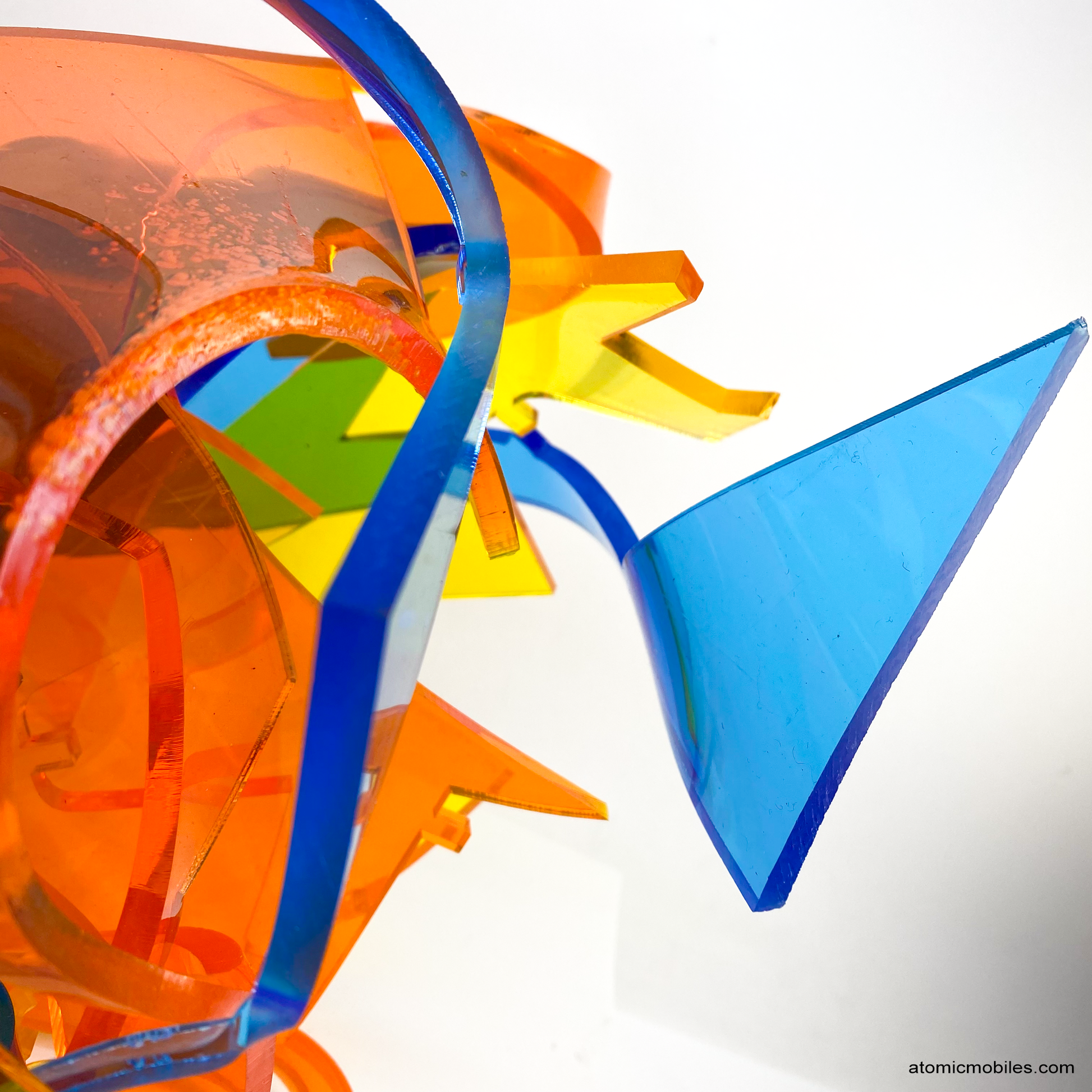 Closeup of Euphoria - mesmerizing Colorful abstract plexiglass acrylic abstract art sculpture in tranparent orange, yellow, blue - one of a kind modern art by AtomicMobiles.com