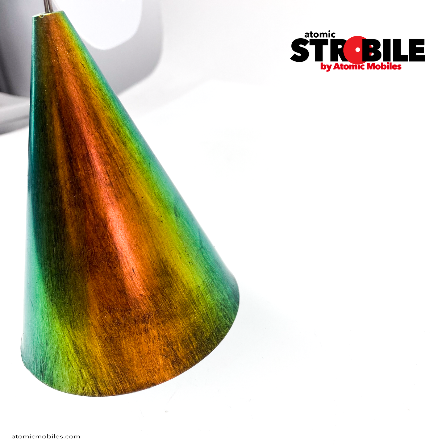Closeup of gorgeous PRISM metallic-look base art sculpture - The Strobile Modern Art Tabletop Kinetic Mobile - with white mobile shapes and color changing cone base by AtomicMobiles.com