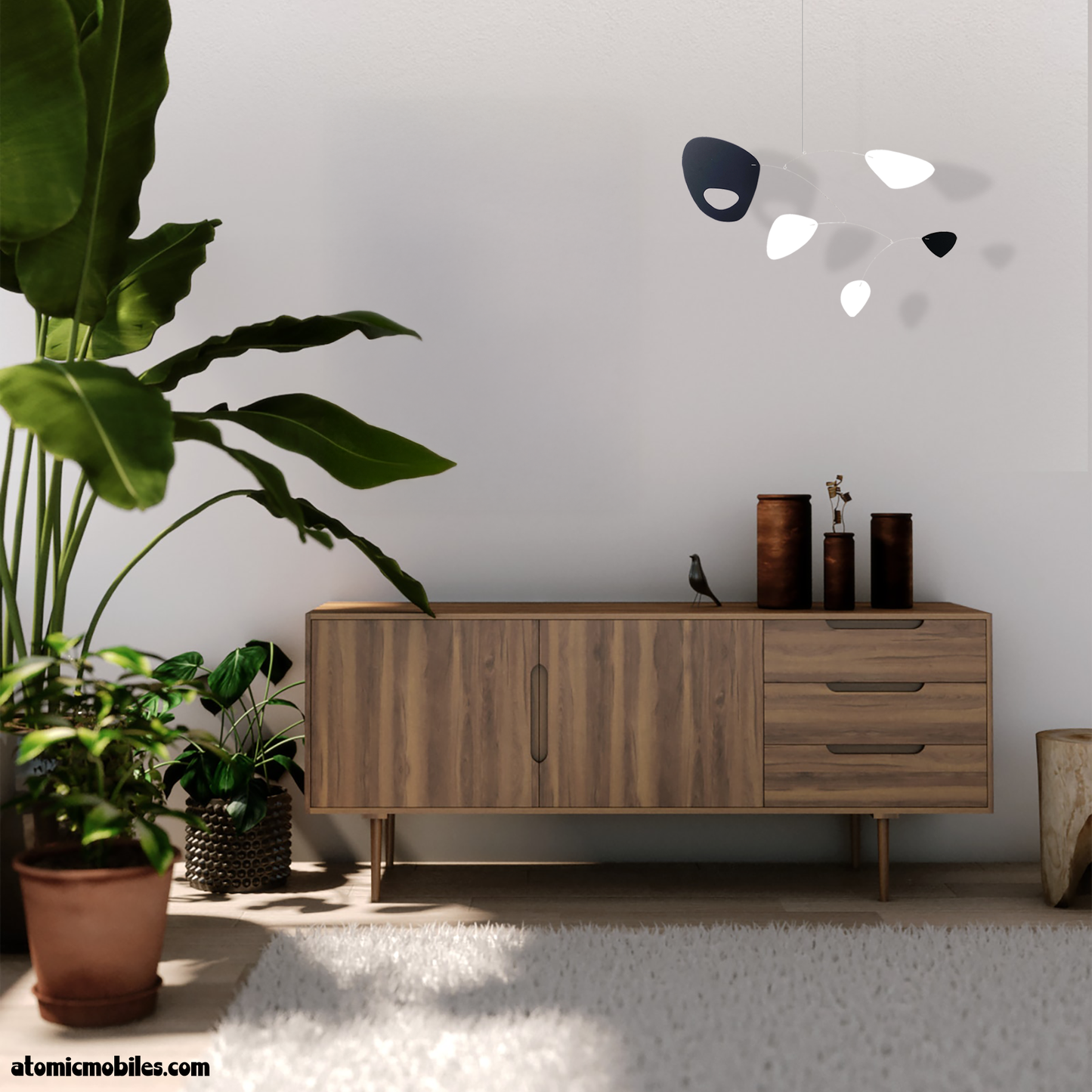 Mid century modern room with wood credenza, plants, and shag rug featuring hanging kinetic art mobile in black and white interpreted with permission from SHAG the artist by AtomicMobiles.com from Recent Acquisistion fine art painting