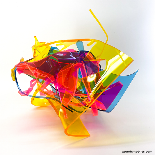 Bold colorful tabletop abstract modern art sculpture stabile in blue, yellow, hot neon pink, orange, and green featuring entangled acrylic plastic by Debra Ann of AtomicMobiles.com
