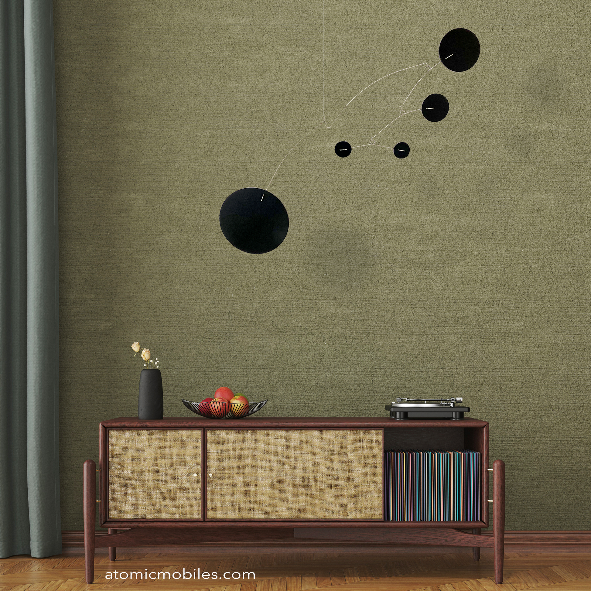 The Moderne Hanging Art Mobile in all Black in mid century style room with record player turntable, fruit basket, record LP albums, credenza, with dark green wall and parquet wood floor - by AtomicMobiles.com