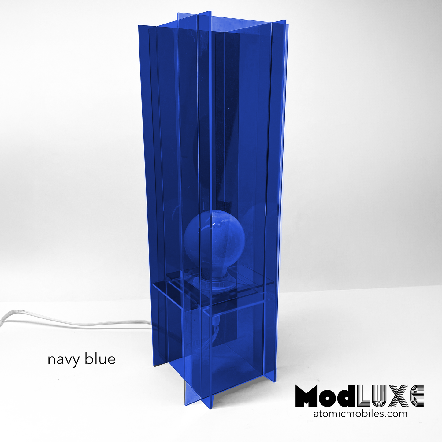 ModLuxe in mod 1970s transparent navy blue acrylic. Retro groovy space age table lamp for modern home decor made by AtomicMobiles.com