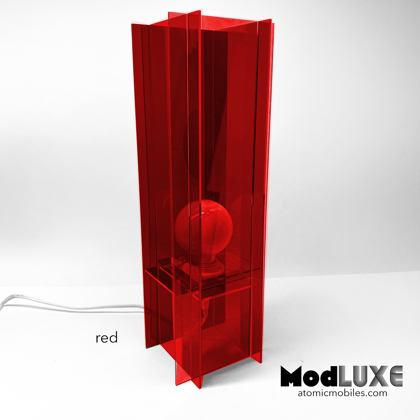 ModLuxe in mod 1970s transparent red acrylic. Retro groovy space age table lamp for modern home decor made by AtomicMobiles.com
