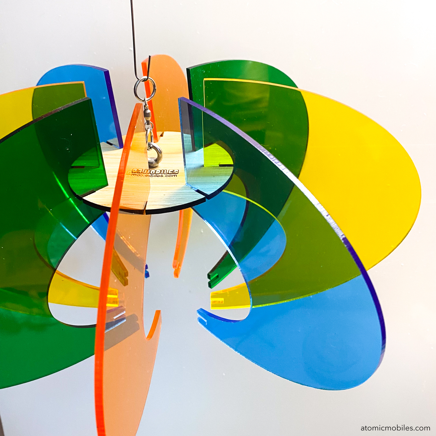 Orbit Space Age RotaMobile kinetic hanging art mobile in clear Orange, Yellow, Green, and Blue acrylic plexiglass and wood center by AtomicMobiles.com
