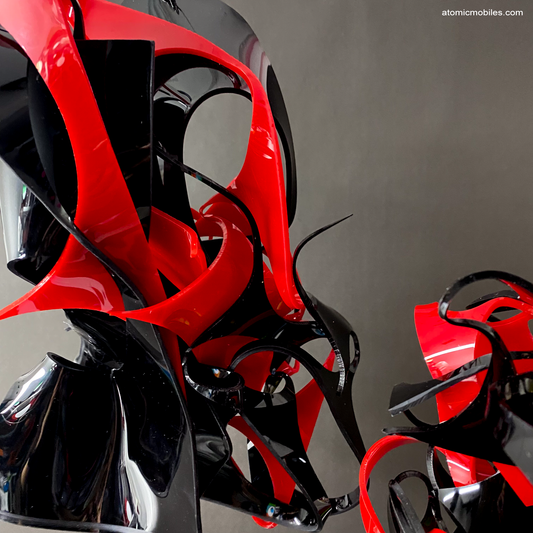 Closeup of dramatic trio of 3 black and red abstract art mobiles made from plexiglass acrylic - unique one of a kind kinetic art by AtomicMobiles.com