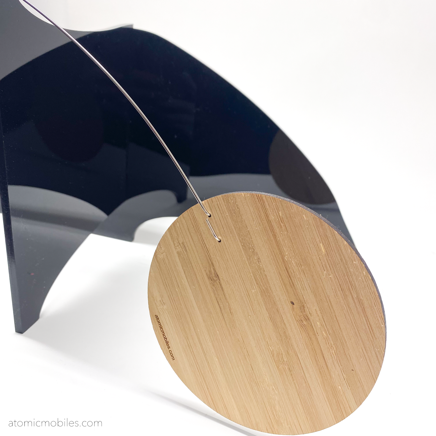 Closeup of The Moderne Elegant Kinetic Art Stabile Sculpture with glossy black acrylic plexiglass base and bamboo wood shapes - custom made art in Los Angeles by AtomicMobiles.com