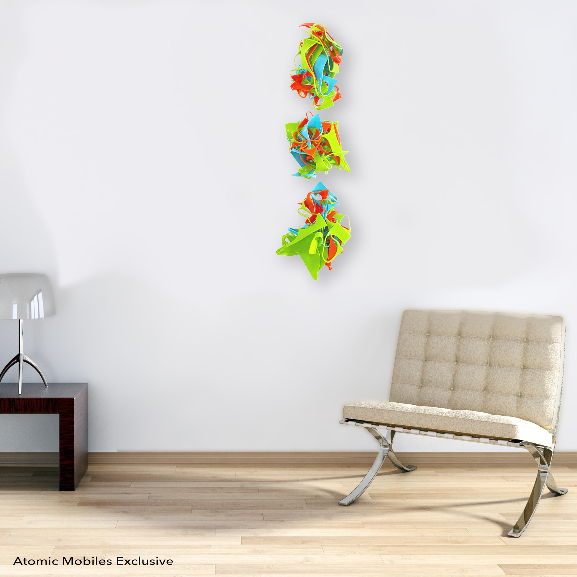 Colorful 3D wall art hanging next to modern beige barcelona chair in a vertical row in Lime Green, Aqua Blue, and Orange - recycled acrylic abstract 3D wall art by AtomicMobiles.com