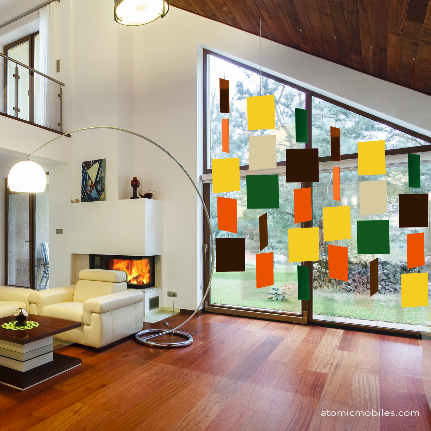 Gorgeous contemporary room with vaulted ceiling, wood floor, and floor to ceiling vaulted windows with mid century modern 1970 inspired hanging art mobile in cream, yellow, olive green, brown and orange - MODcast mobiles by AtomicMobiles.com