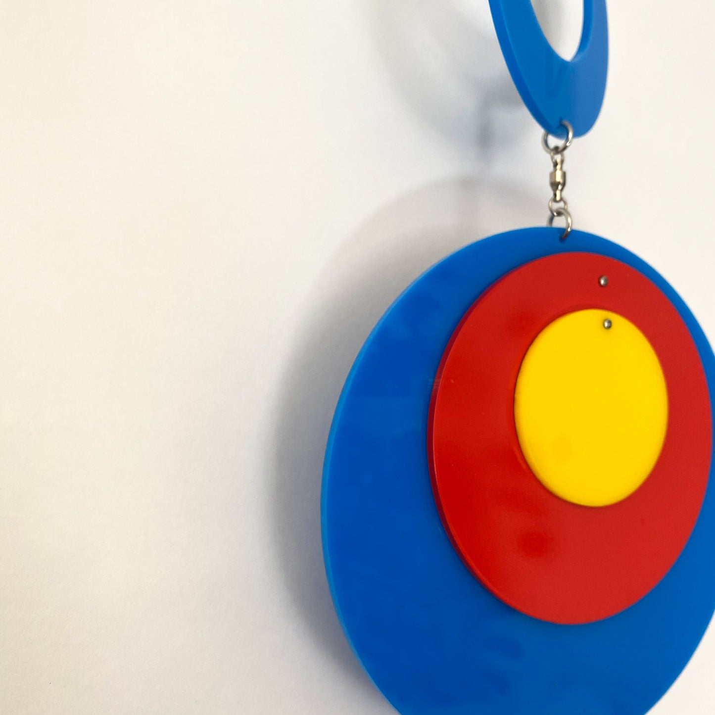 Another closeup of Groovy Twirly Blue Multi Color Vertical Kinetic Mobile in Blue Red and Yellow by AtomicMobiles.com