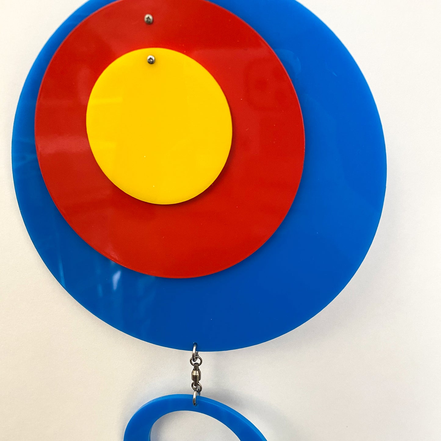 Closeup of Groovy Twirly Blue Multi Color Vertical Kinetic Mobile in Blue Red and Yellow by AtomicMobiles.com