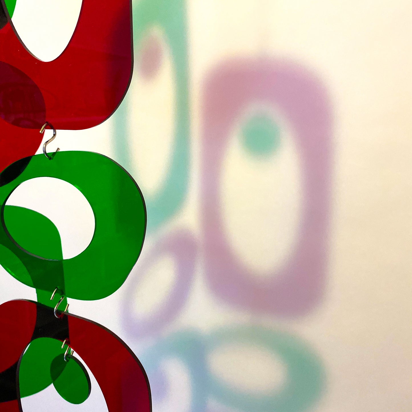 Red and green clear acrylic mid century modern Christmas Decoration - Vertical art mobile DIY Kit with colorful shadows on the wall by AtomicMobiles.com