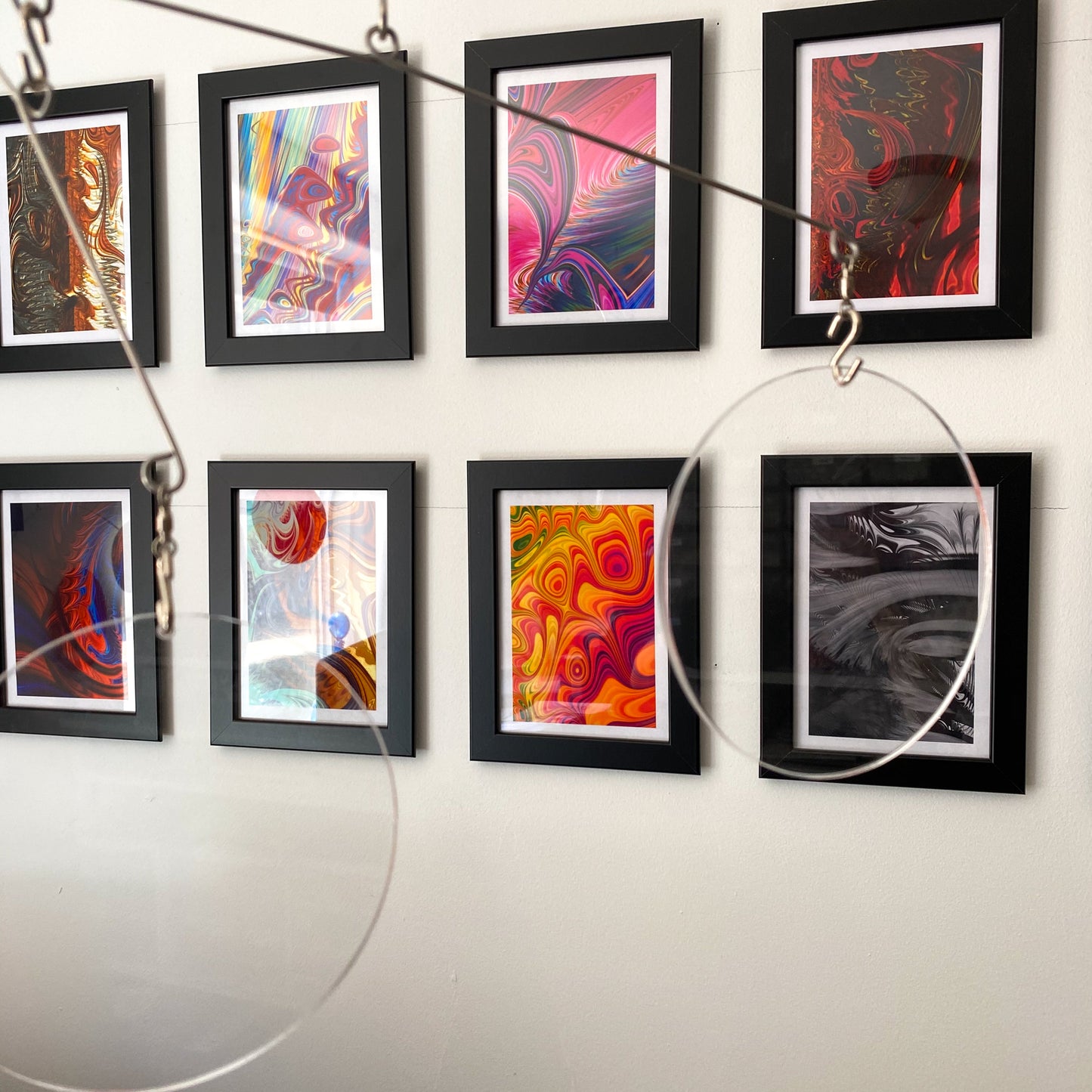 Clear Acrylic Atomic Mobiles in front of MiniMOD abstract colorful art prints by AtomicMobiles.com