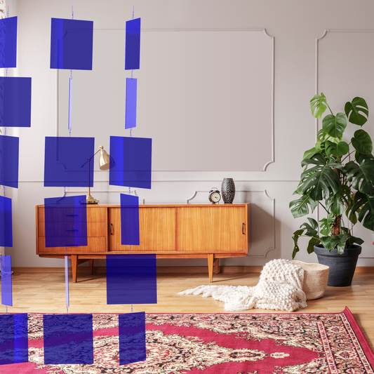 Clear Navy Blue MODcast Room Divider in modern high ceiling room with wood credenza, plant, and oriental rug - hanging room dividers by AtomicMobiles.com