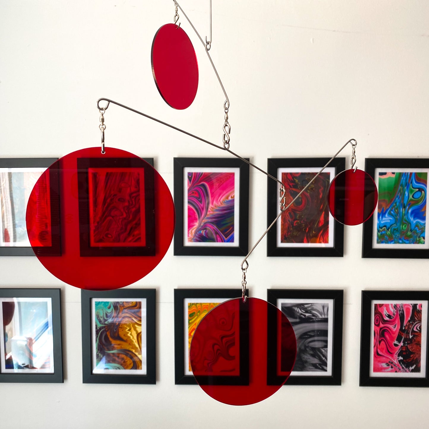 Clear Red Atomic Mobile with colorful abstract art showing through by AtomicMobiles.com