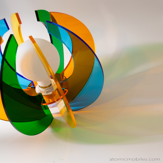 Another view of gorgeous retro mid century modern style acrylic plexiglass table top lamp in clear orange, green, yellow, and blue by AtomicMobiles.com