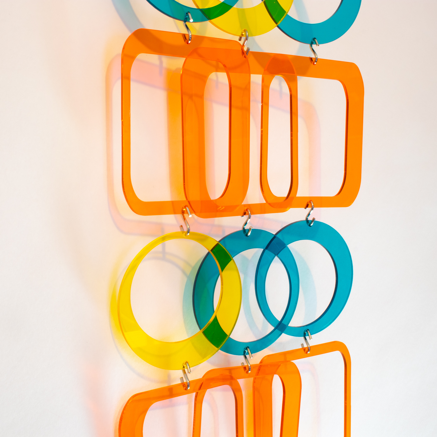 Side closeup of beautiful DIY Kit to make mobile, room divider, window treatment, or wall art in clear orange, teal, yellow by AtomicMobiles.com