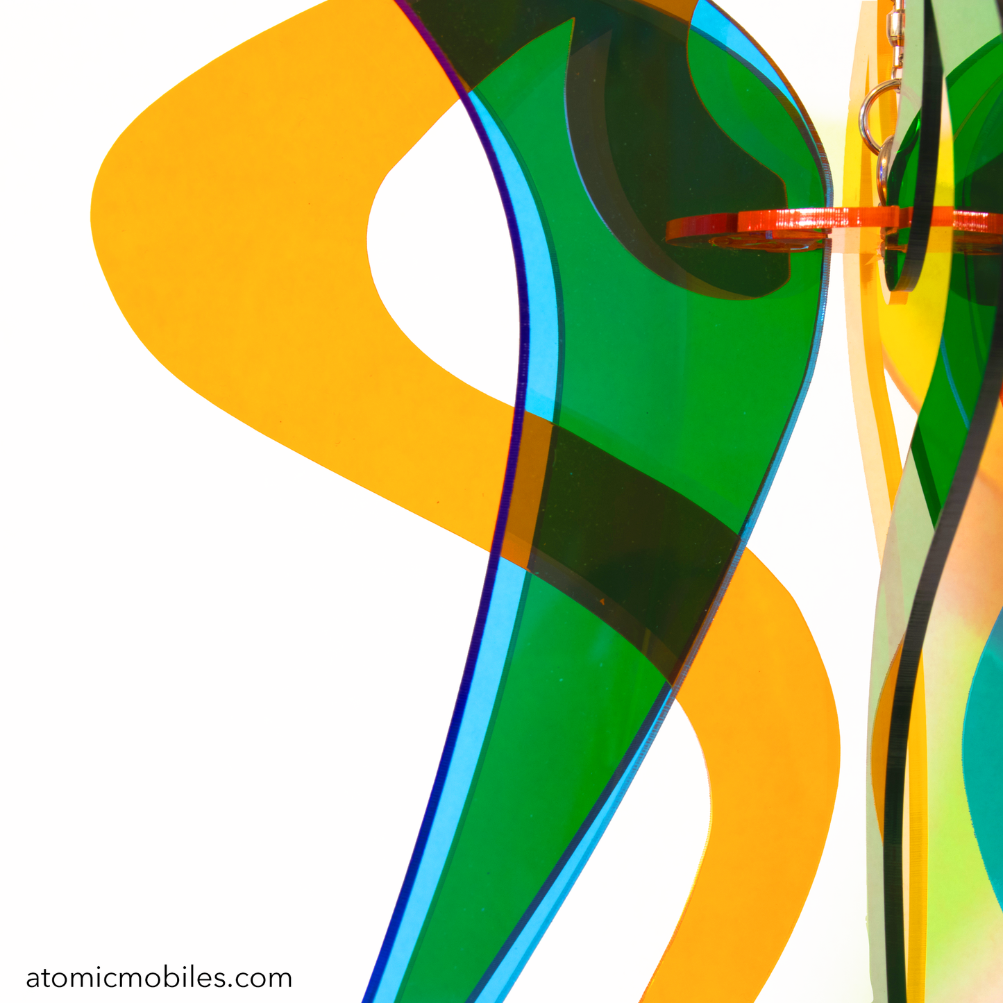 Closeup of Genie Space Age RotaMobile kinetic hanging art mobile in clear Orange, Yellow, Blue, and Green acrylic plexiglass by AtomicMobiles.com