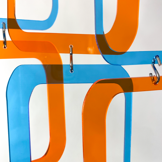 Closeup of Stunning blue and orange clear acrylic retro 1970s room divider, window curtain, wall art, and mobile DIY Kit by AtomicMobiles.com