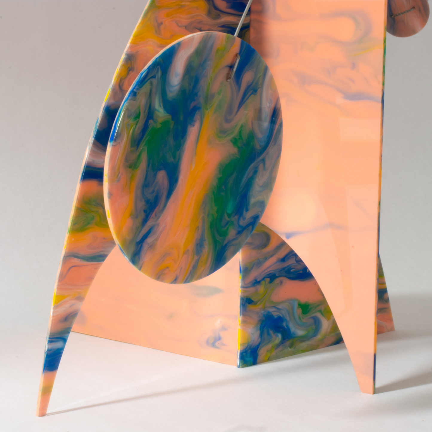Side closeup of Peachy Moderne Art Stabile with beautiful swirls of green, orange, pink and green colors by AtomicMobiles.com