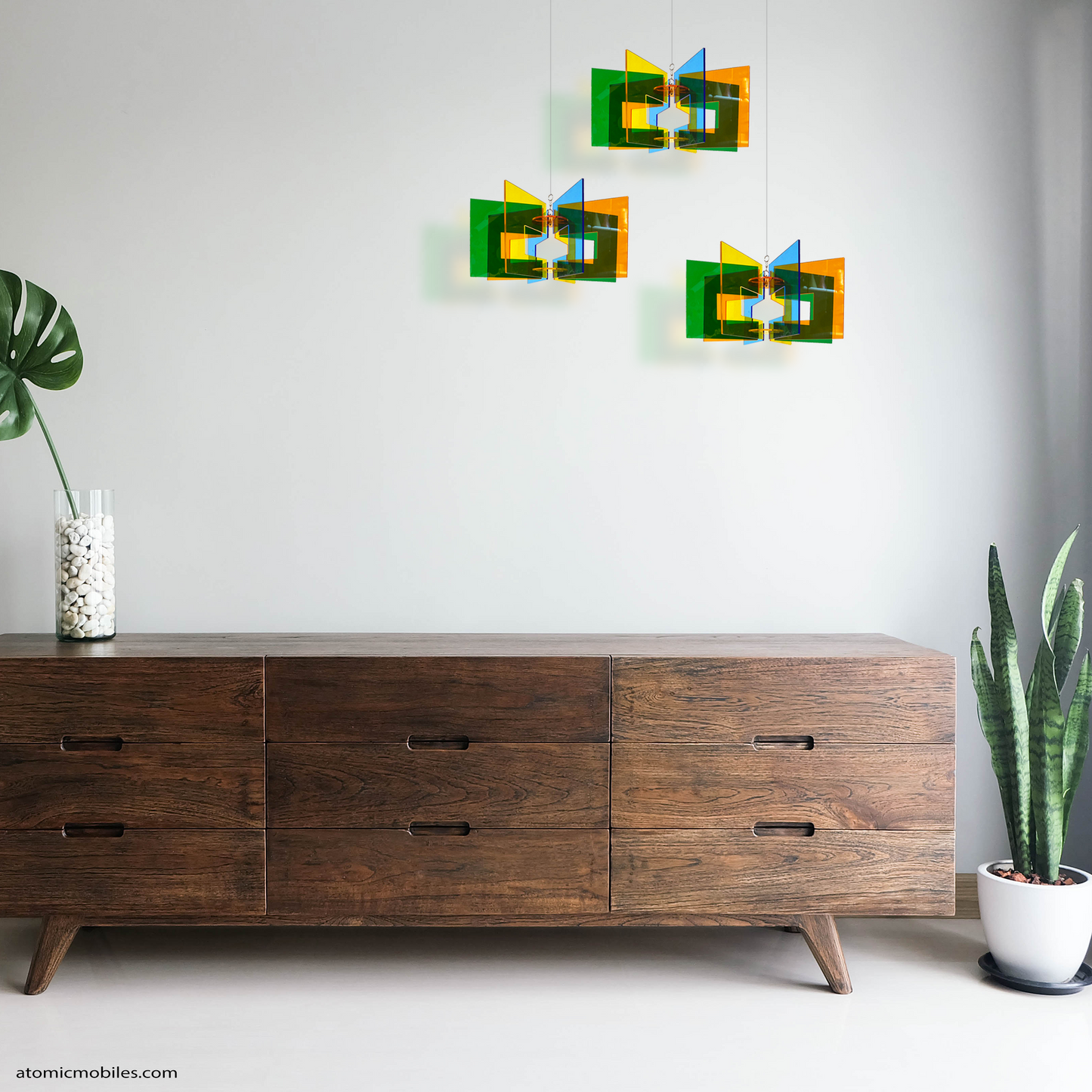3 Space Age RotaMobiles in a grouping over wood credenza sideboard furniture with plants - kinetic art mobiles by AtomicMobiles.com