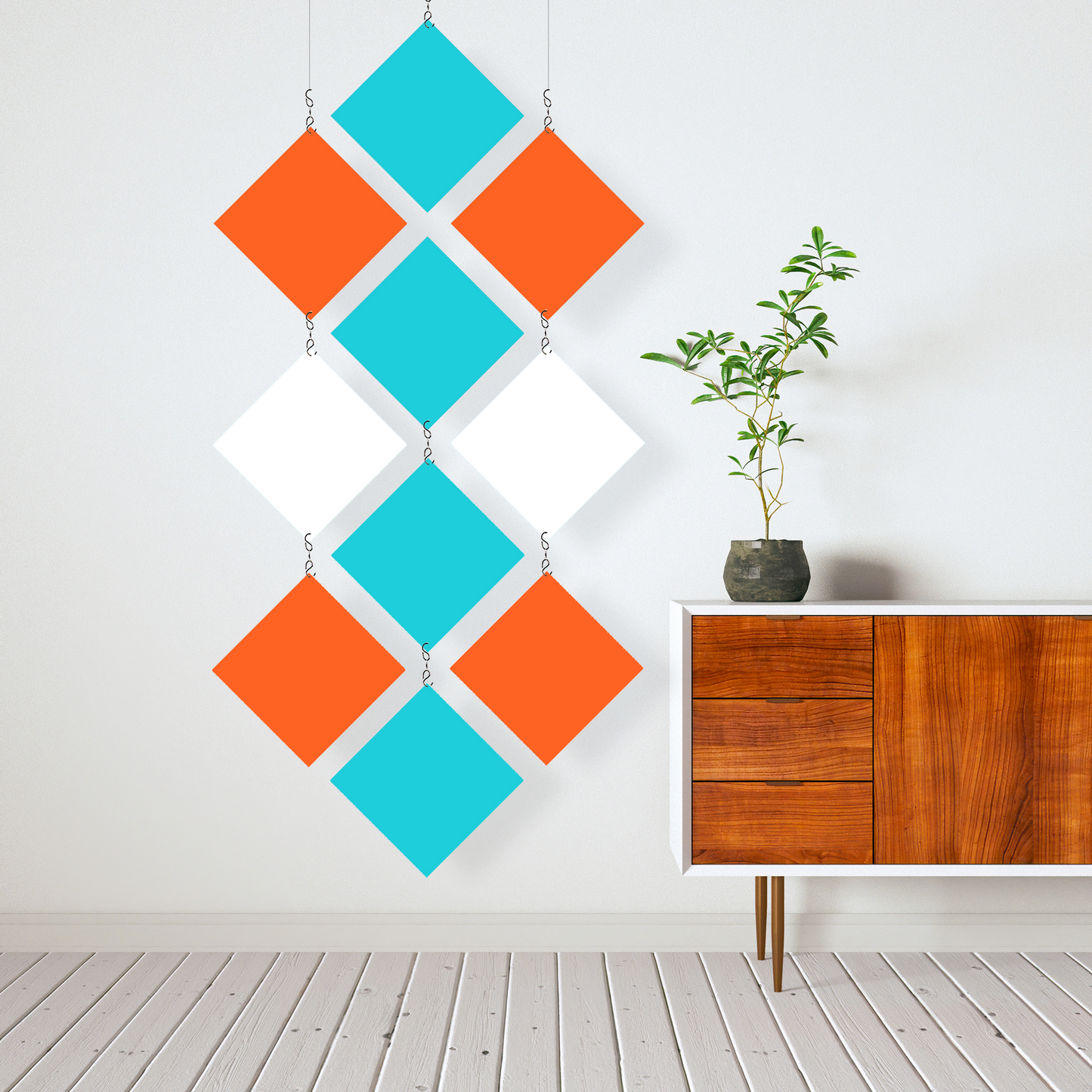 Mid Century Modern Hanging Kinetic Room Divider and Mobile in Orange, Aqua, and White next to modern wood credenze sideboard with plant in white room - MODcast colorful room divider mobiles by AtomicMobiles.com