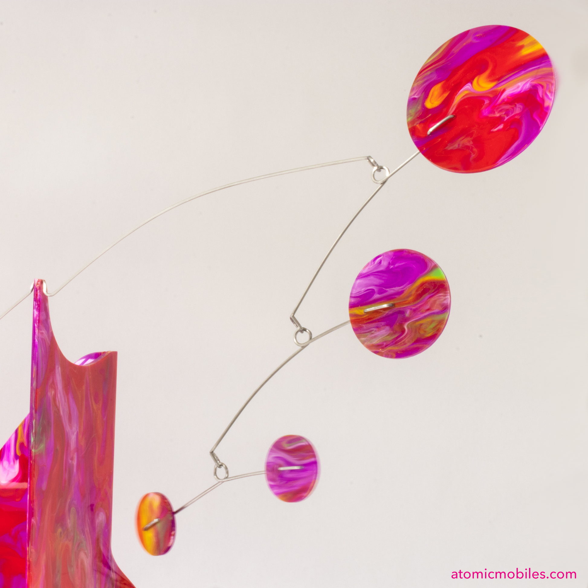 Closeup of circles of Fuchsia Fling Modern Art Stabile - table top kinetic art mobile in hot pink, purple, and red, handmade in Los Angeles by Debra Ann of AtomicMobiles.com