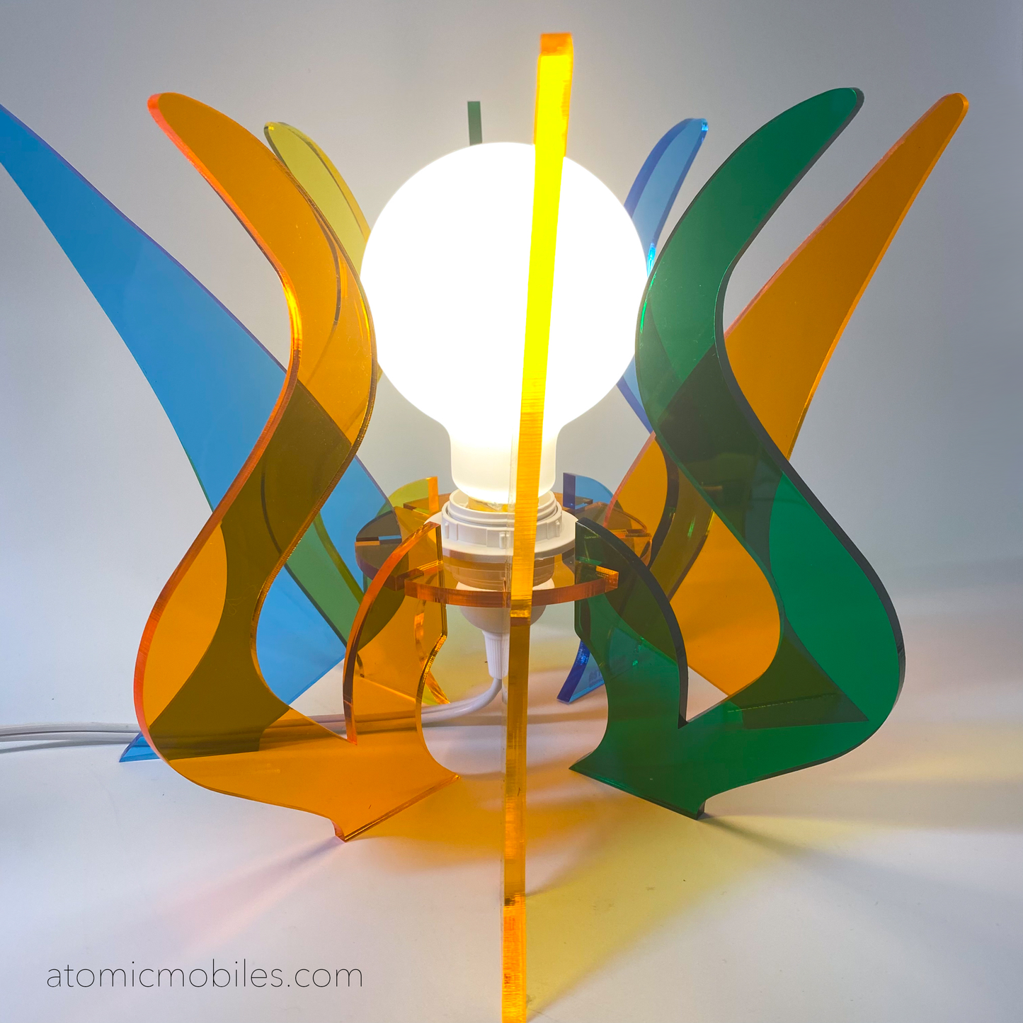 Lit up Genie Space Age Lamp in clear acrylic colors of orange, blue, yellow, and green- retro mid century modern groovy lighting by AtomicMobiles.com