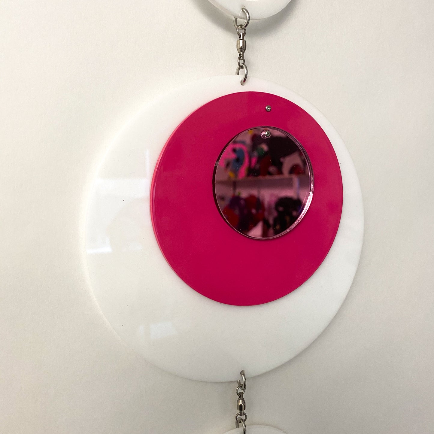 Closeup of Groovy DOTS in white, hot pink, and pink mirror showing reflection by AtomicMobiles.com