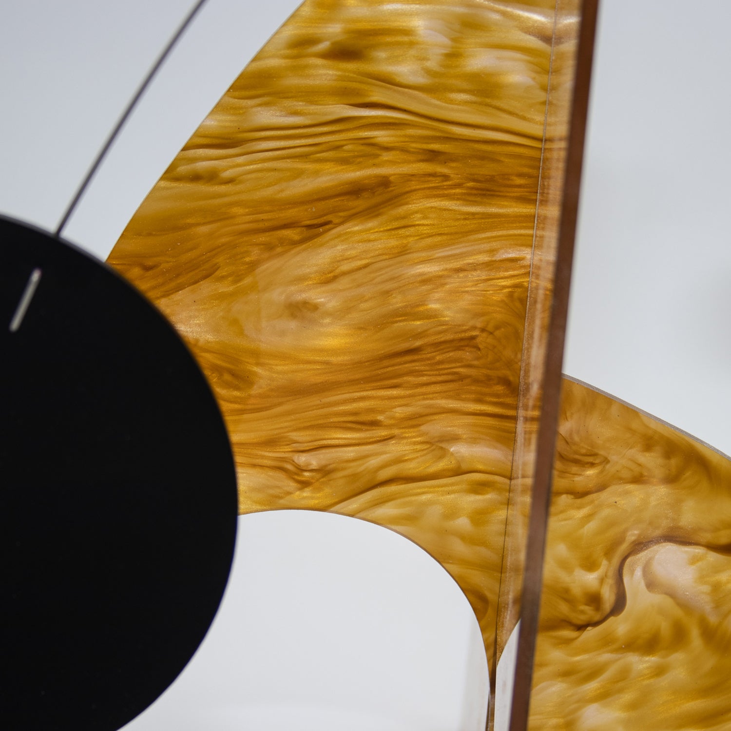 Moderne Exotics Stabile - beautiful marbled gold closeup with black circle - table top mobiles by AtomicMobiles.com
