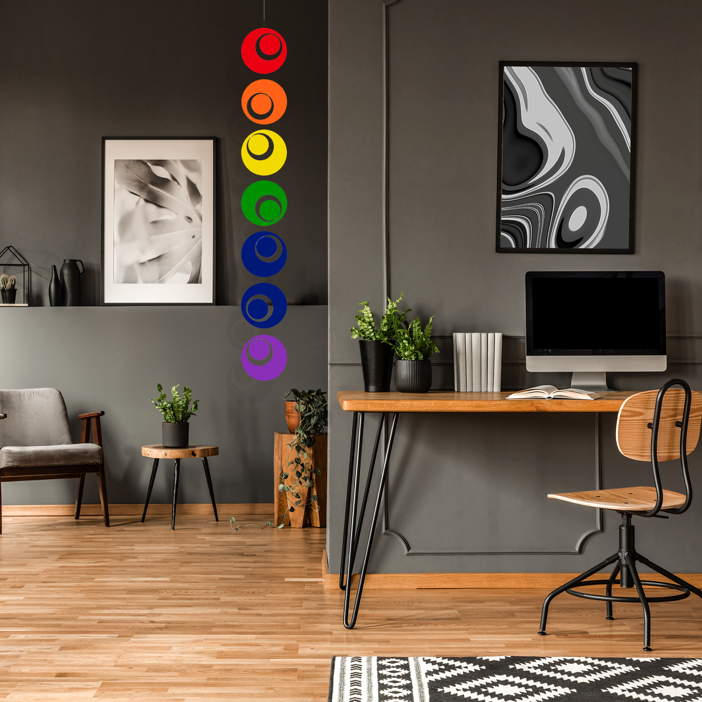 Dark room home office with desk, computer, and Rainbow Groovy Hanging Art Mobile by AtomicMobiles.com
