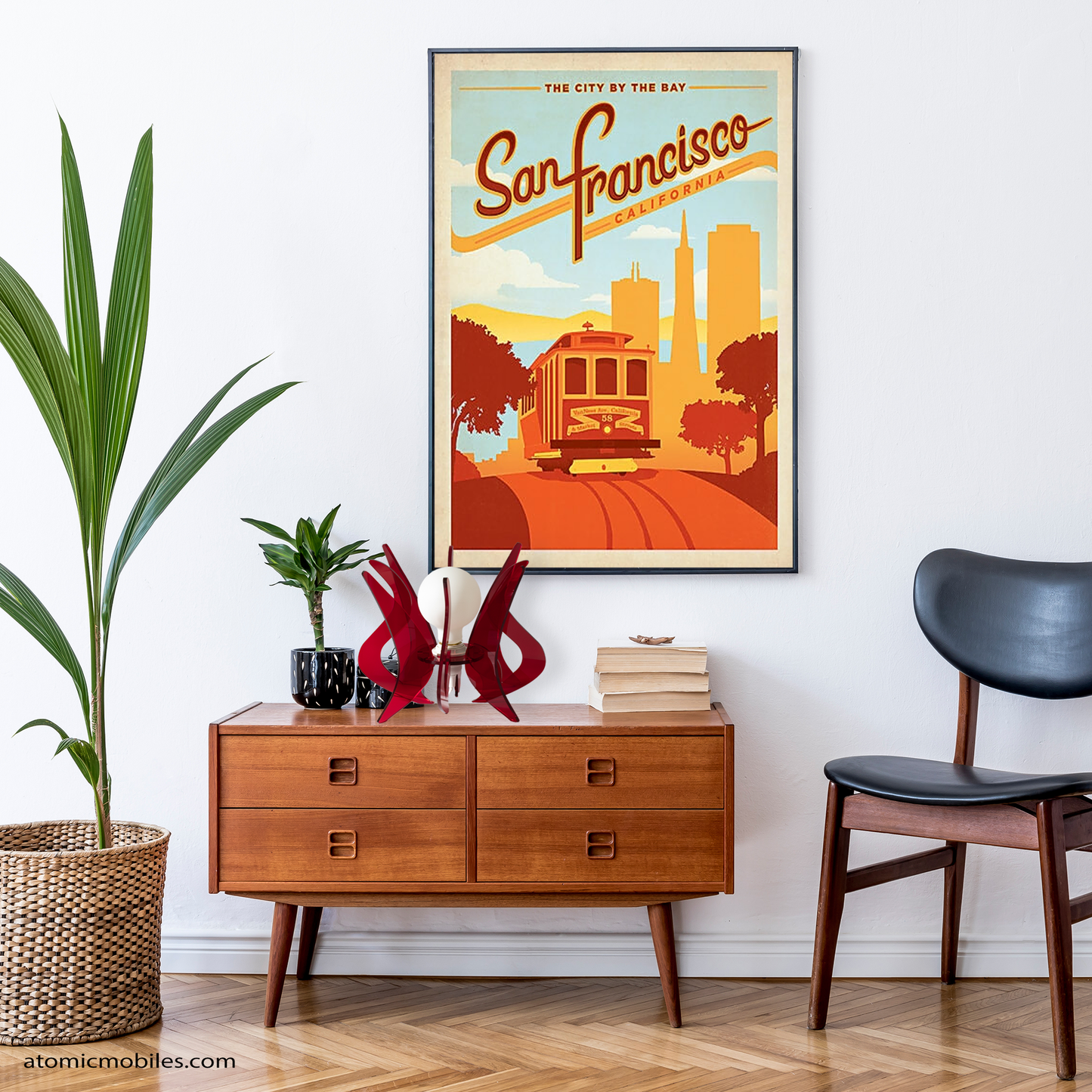ASTROLUMA Space Age Retro Table Top Lamp in clear red color acrylic plexiglass plastic with large globe light bulb on a danish mid century modern credenza sideboard furniture and framed San Francisco poster with plants - lamp made in Los Angeles, California USA by AtomicMobiles.com