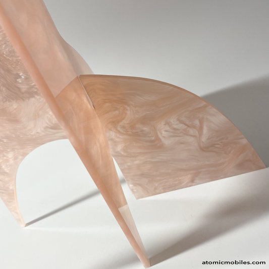 Side view of lovely baby pink marbled acrylic Moderne Art Stabile Sculpture with black circles by AtomicMobiles.com