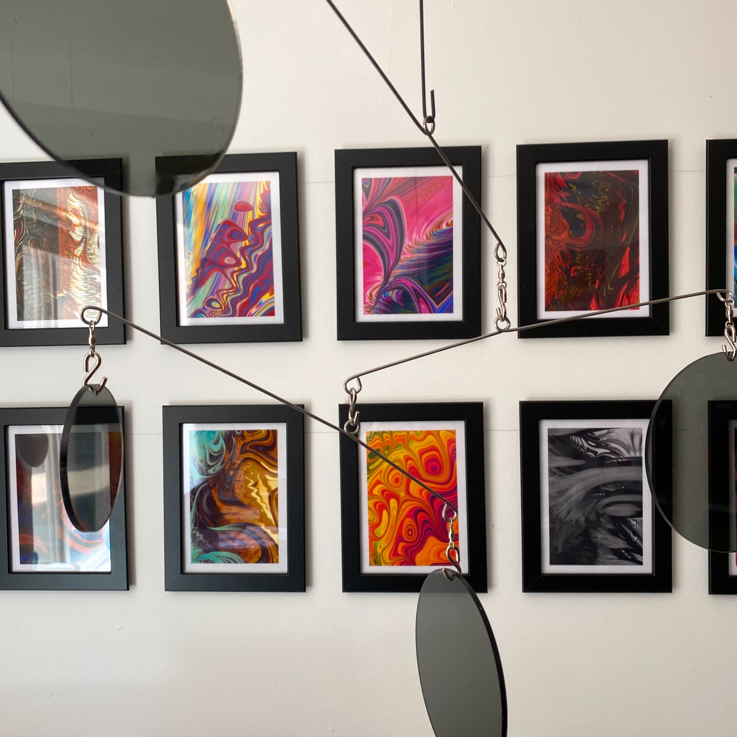 Clear Smoky Gray Atomic Mobiles in front of MiniMOD abstract colorful art prints by AtomicMobiles.com