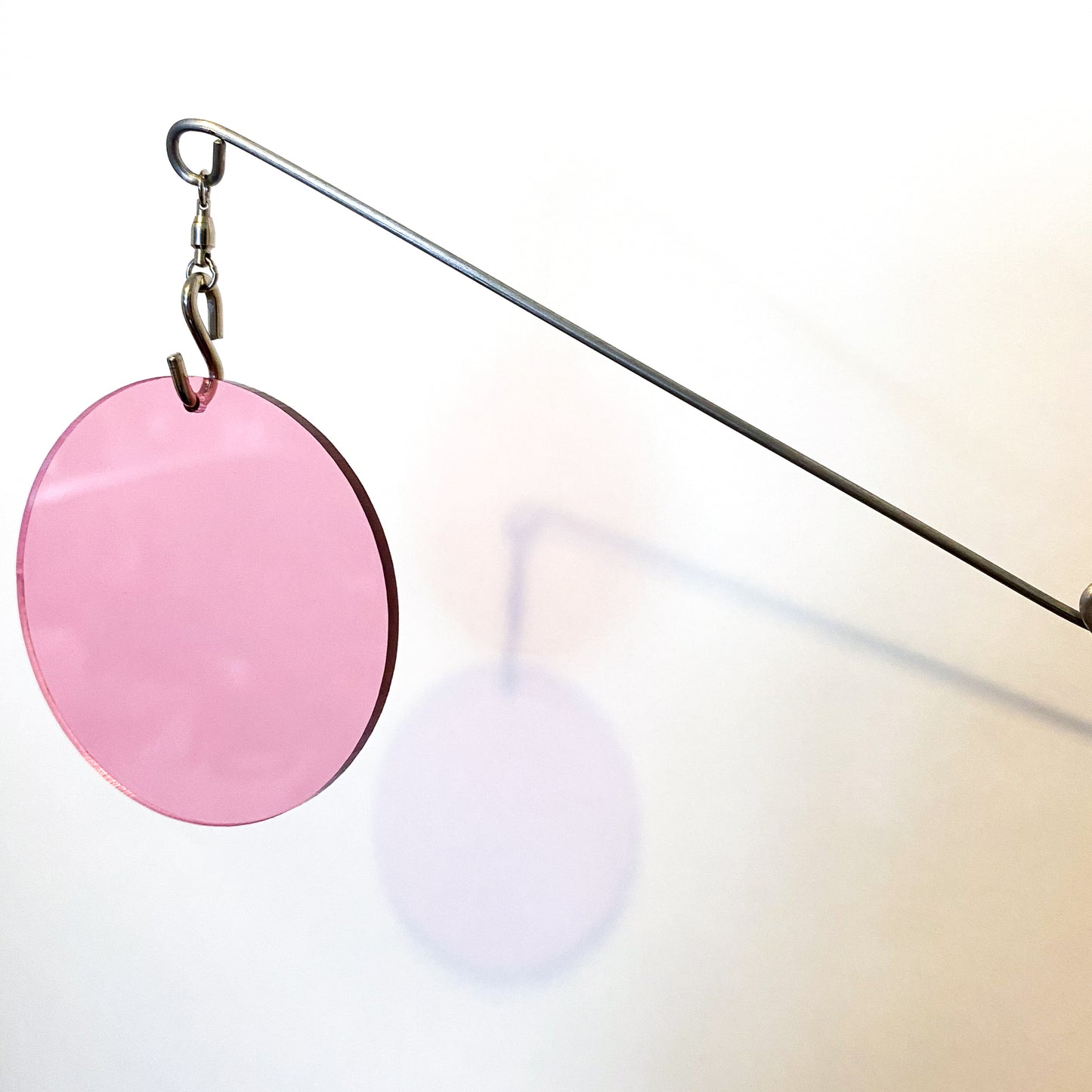 Closeup of Clear Pink Acrylic Atomic Mobile - kinetic hanging art mobiles for modern home decor by AtomicMobiles.com