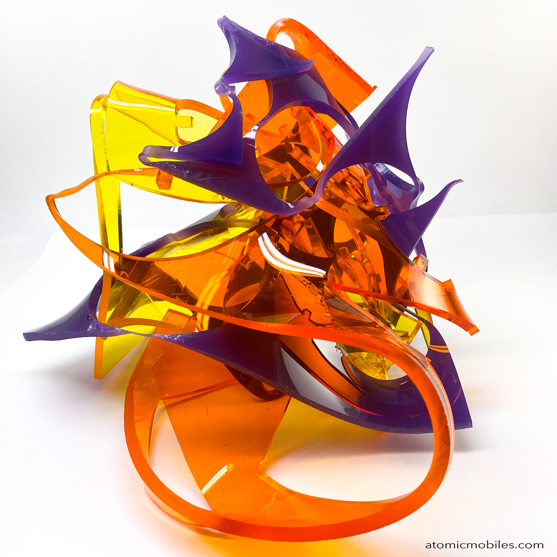 another view of one of a kind Stellar abstract art sculpture in bold clear orange, clear yellow, and opaque purple - made from recycled/upcycled acrylic plexiglass by Debra Ann in Los Angeles of AtomicMobiles.com