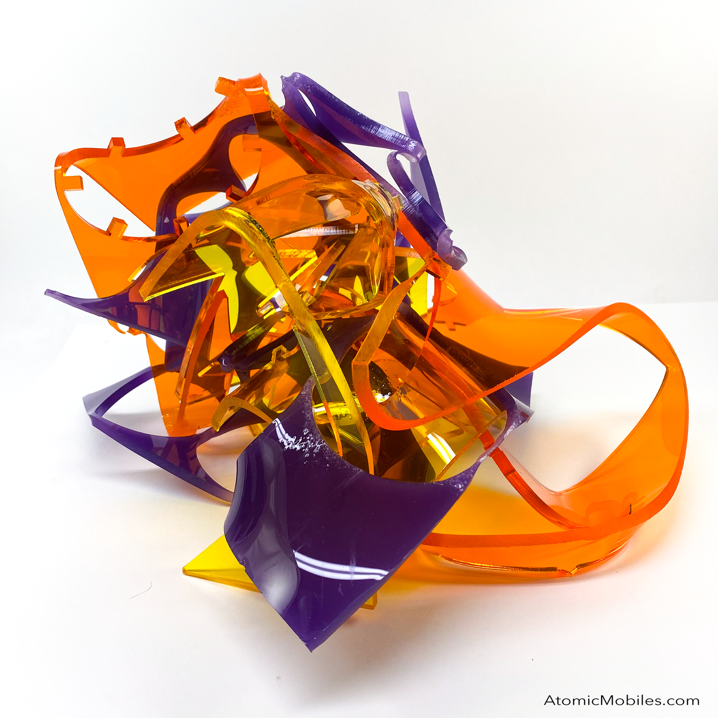Another view of one of a kind Stellar abstract art sculpture in bold clear orange, clear yellow, and opaque purple - made from recycled/upcycled acrylic plexiglass by Debra Ann in Los Angeles of AtomicMobiles.com