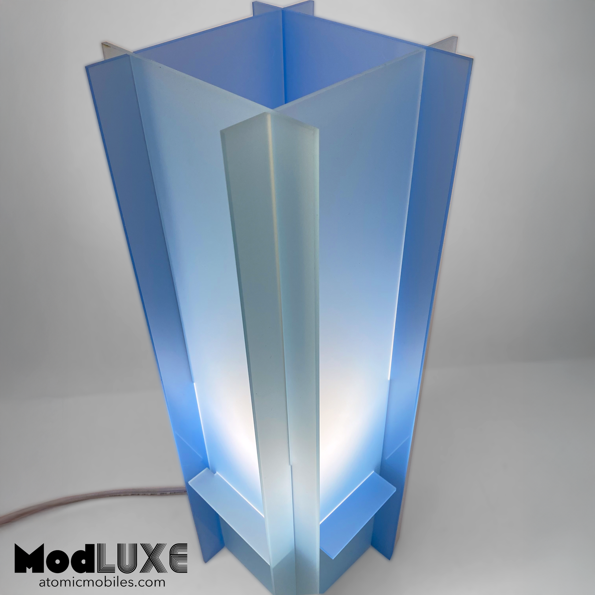 Closeup of stunningly beautiful baby blue table lamp in space age modern style with reversible color by AtomicMobiles.com