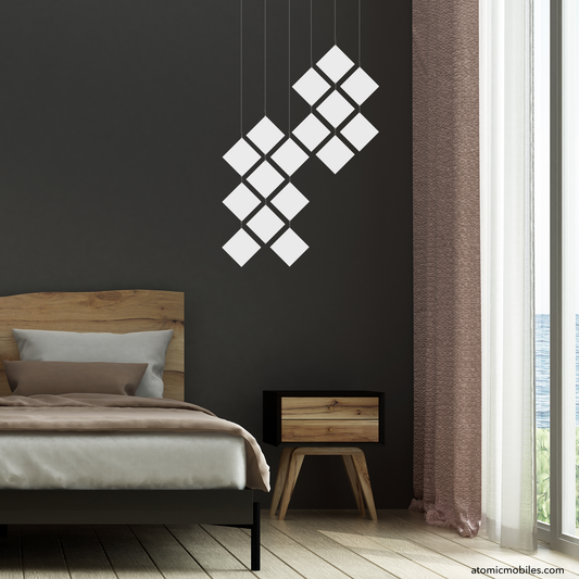 Beautiful White MODCast Mini Diamond Hanging Art Mobile in dark bedroom with wood furniture and drapes, window looking out at ocean - mobile by AtomicMobiles.com