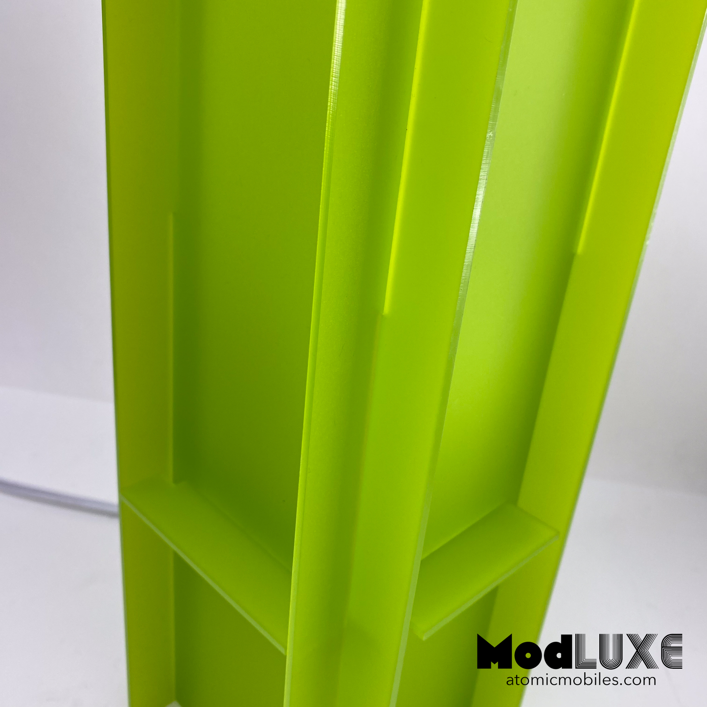 Closeup of stunning frosty matte lime green modern table art lamp made from acrylic plastic by AtomicMobiles.com