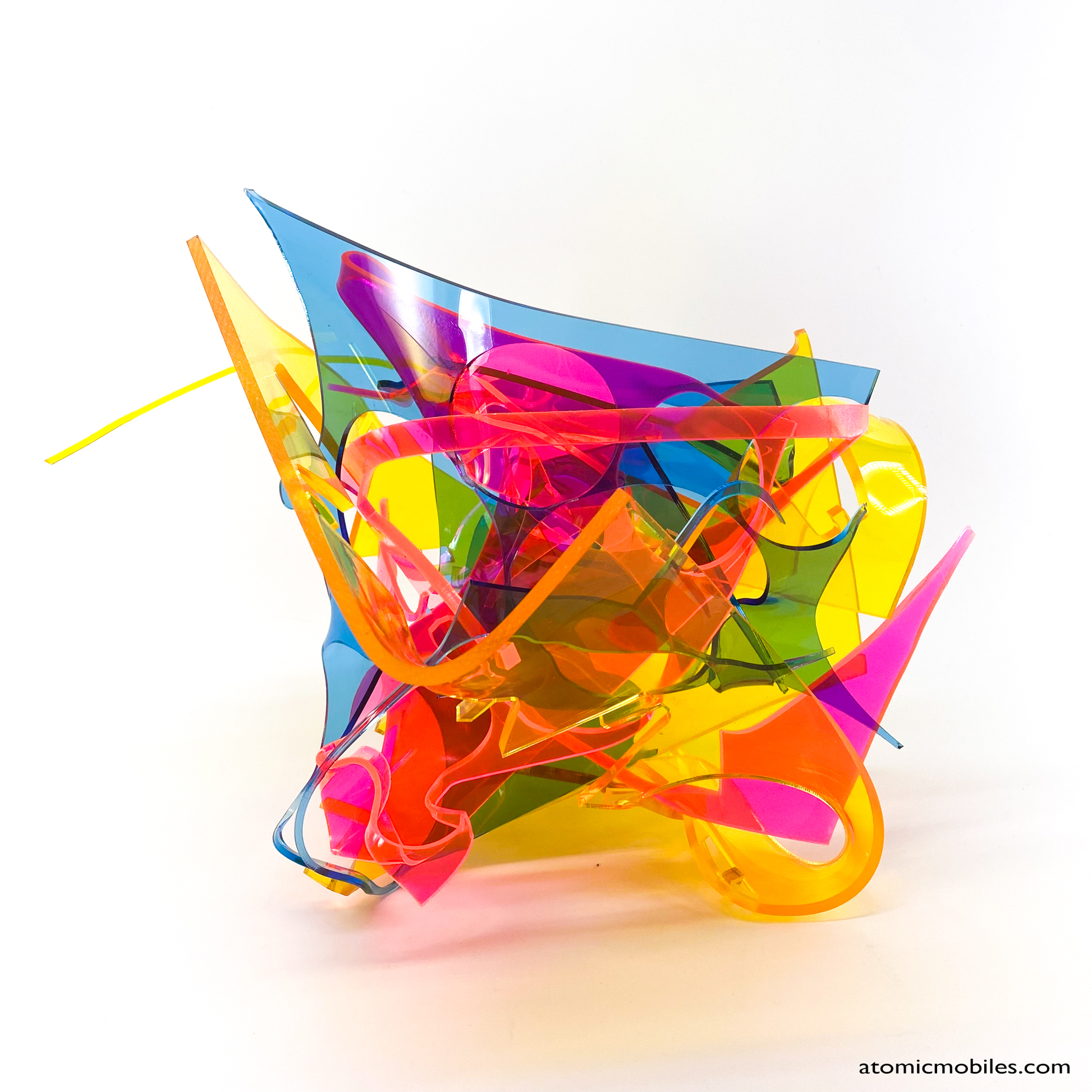 Bold colorful tabletop abstract modern art sculpture stabile in blue, yellow, hot neon pink, orange, and green featuring entangled acrylic plastic by Debra Ann of AtomicMobiles.com