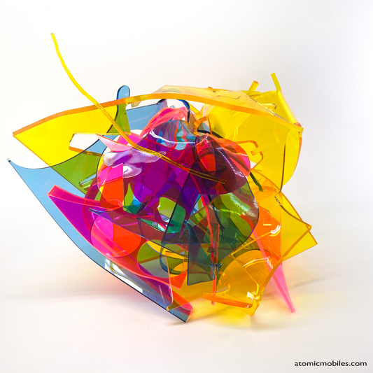 Back view of bold colorful tabletop abstract modern art sculpture stabile in blue, yellow, hot neon pink, orange, and green featuring entangled acrylic plastic by Debra Ann of AtomicMobiles.com