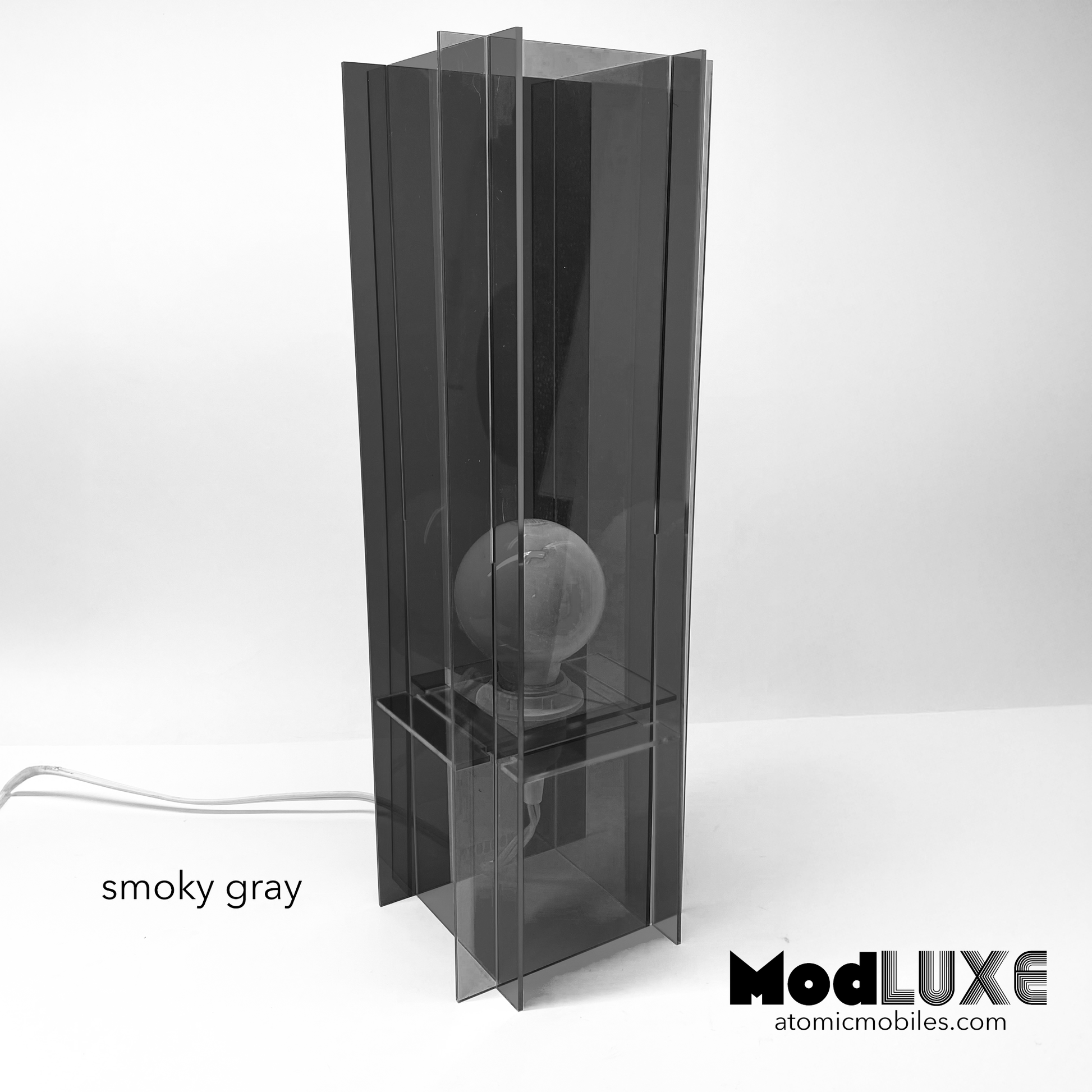 ModLuxe in mod 1970s transparent smoky gray acrylic. Retro groovy space age table lamp for modern home decor made by AtomicMobiles.com