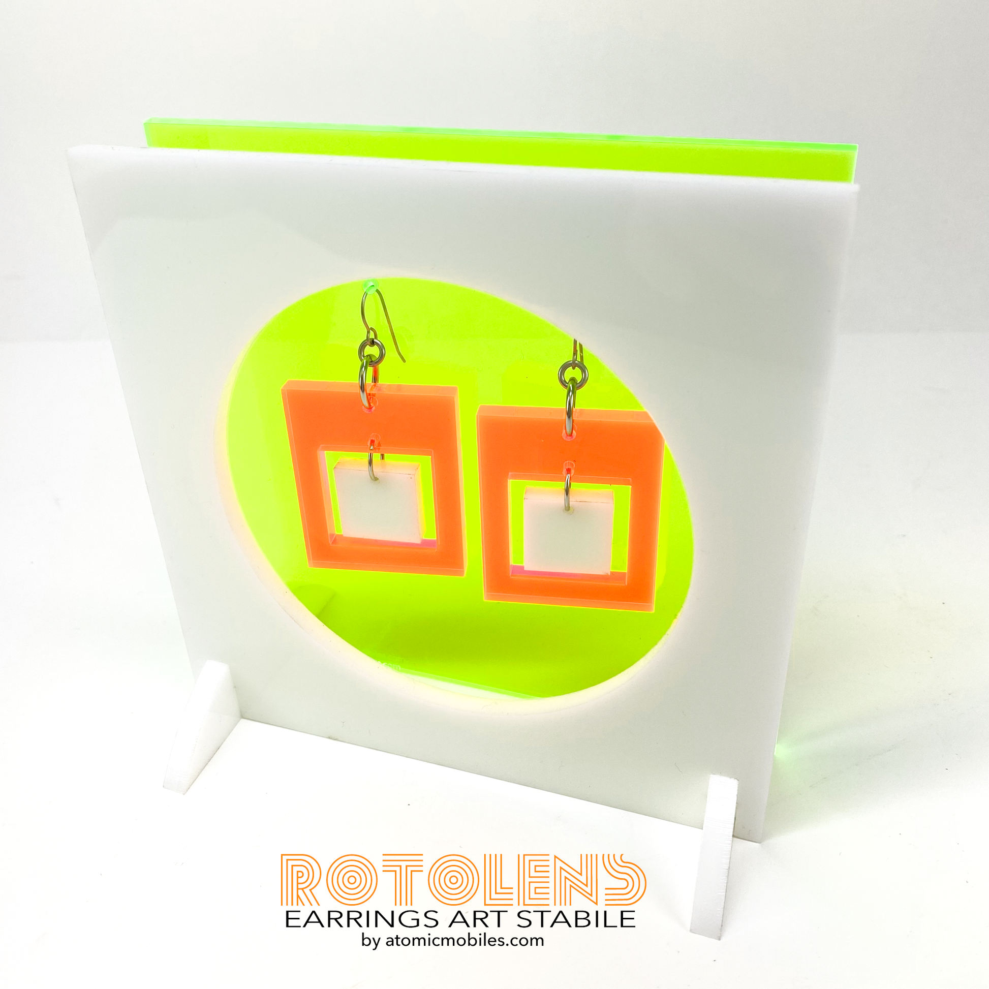 Stunning Art Earrings Stabile Set featuring transparent neon green backing with orange and white earrings - mid century modern art for Groovy People by AtomicMobiles.com
