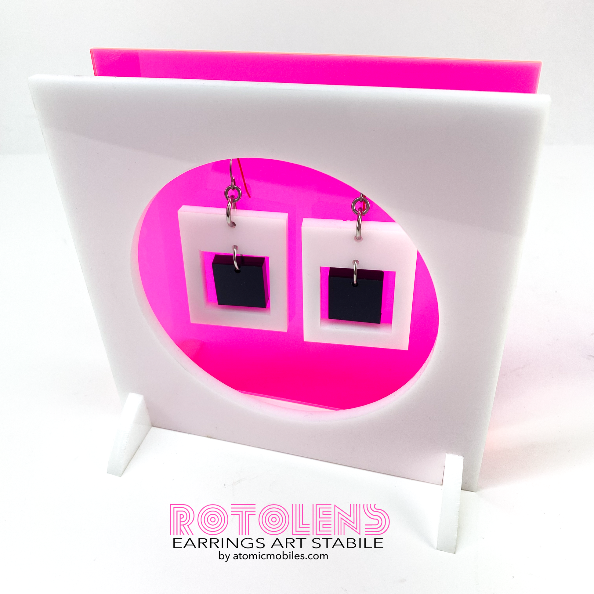 Stunning Art Earrings Stabile Set featuring transparent neon pink backing with white and black earrings - mid century modern art for Groovy People by AtomicMobiles.com